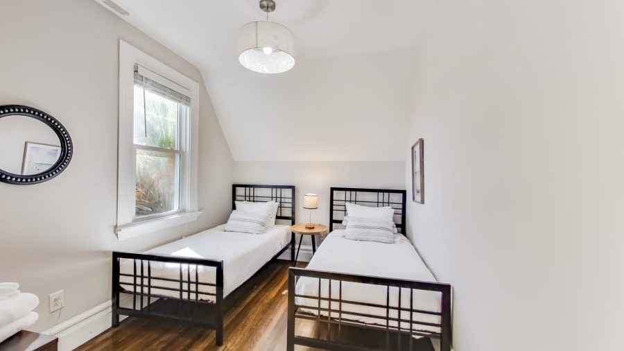 The back upstairs bedroom is just next to the bathroom and features two twin beds and a large closet