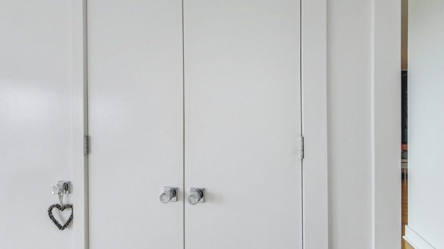 Main floor queen bedroom with en suite bath has plenty of closet space to store clothes. 