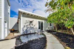 Cottage behind a victorian house.  
The yard/patio/outdoor space is shared with the main house.