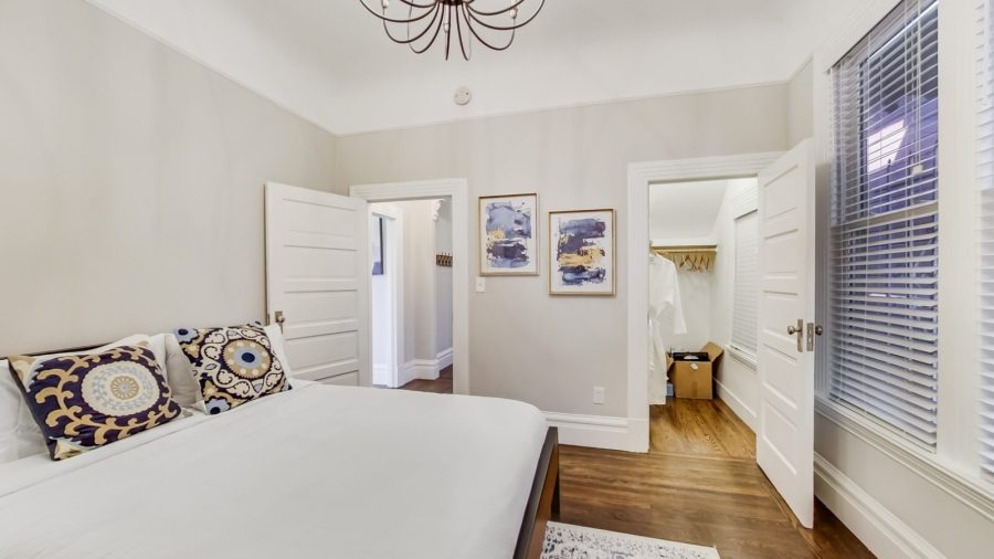 Main level bedroom has a queen bed, en suite bathroom and a standing desk