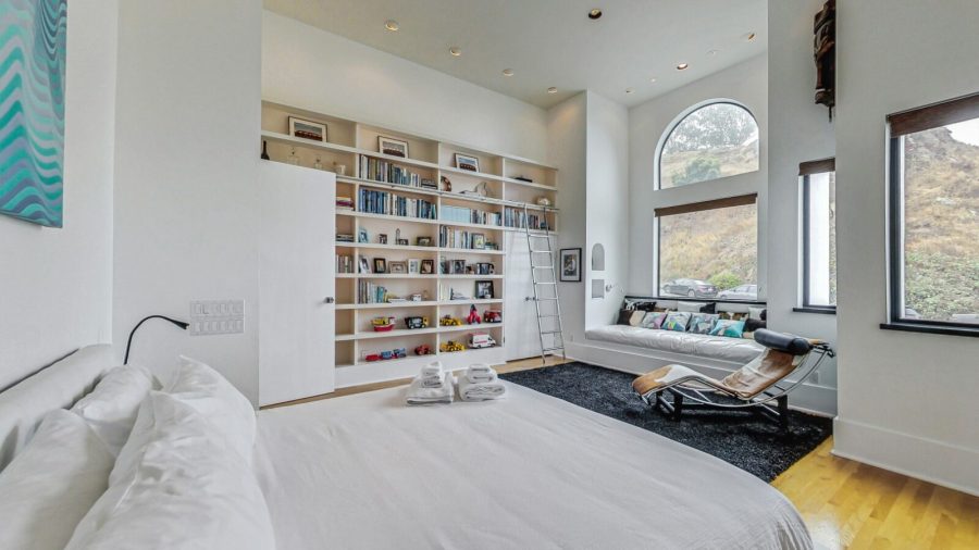 Main floor large bedroom with King bed, across from the shared bathroom. with a view of Tank Hill. 