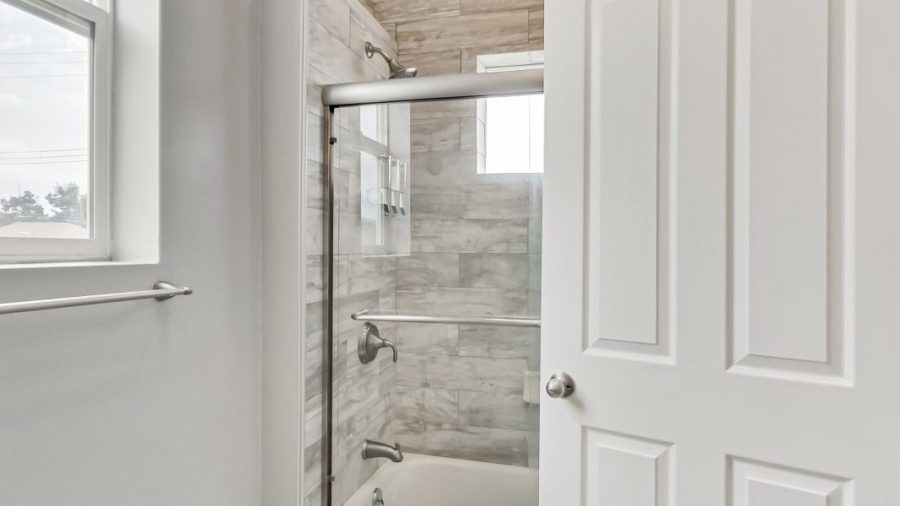 The shared bathroom features a shower over tub layout with Kiehl's shampoo, conditioner, and body wash