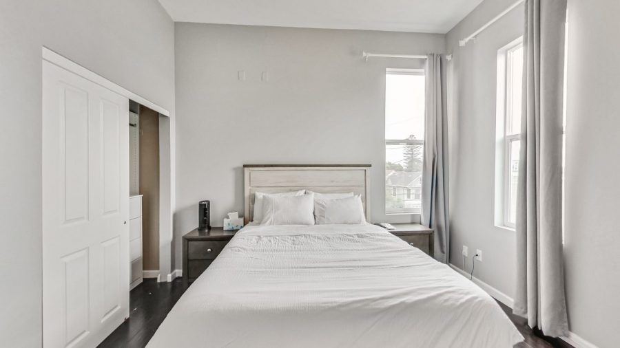 Queen sized bed with window out to the street. 