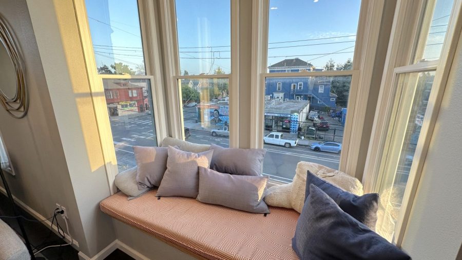 The living room features a cozy bay window with ample light and sunshine; take a break in the sunshine or relax and read a novel