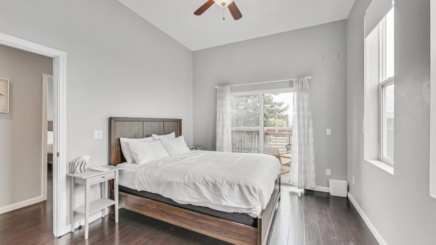 Bedroom has sliding door that leads to the back deck