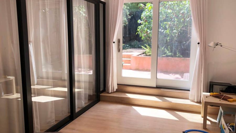 Modern Japanese inspired doors slide to close off the second bedroom