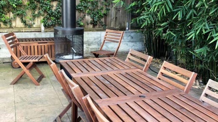 Outdoor seating area by a lush bamboo grove
