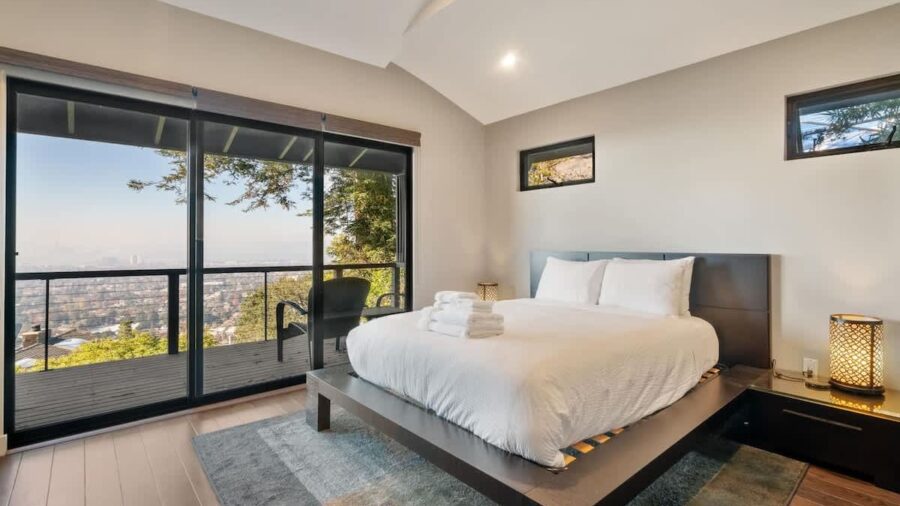 Upstairs bedroom with queen bed and access to upper deck with outstanding views
