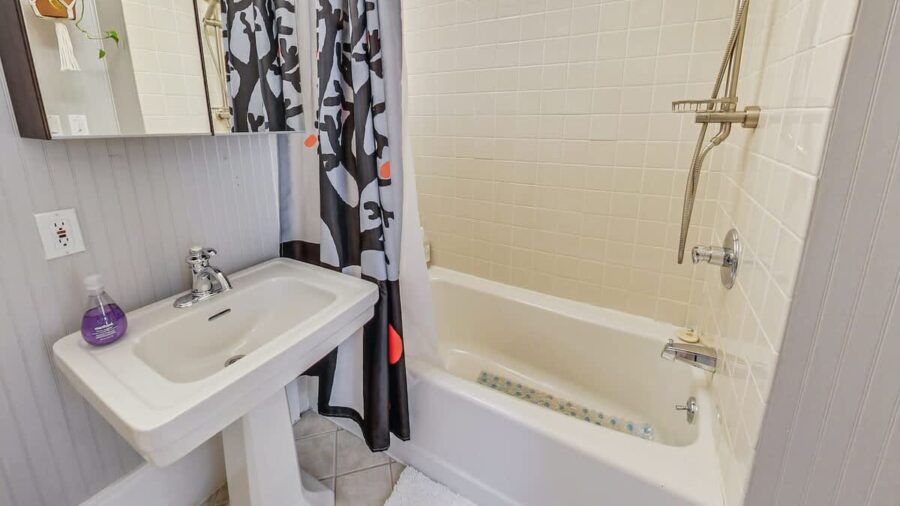 Second bathroom features a shower over tub.  