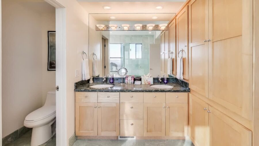 The master bathroom features double sink vanity, separate water closet, a spa bath tub, and a glass enclosed shower