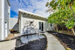 Cottage behind a victorian house.  The yard/patio/outdoor space is shared with the main house.