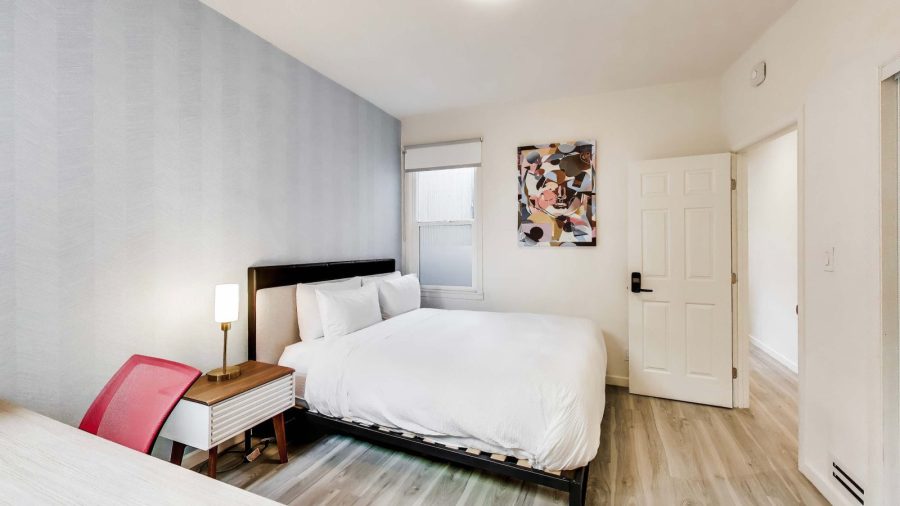 Small bedroom with large walk-in closet and TV